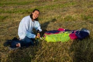 A skydiver packing her kit