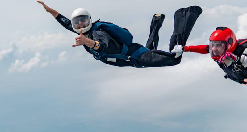 A skydiver posing for a photo mid-jump